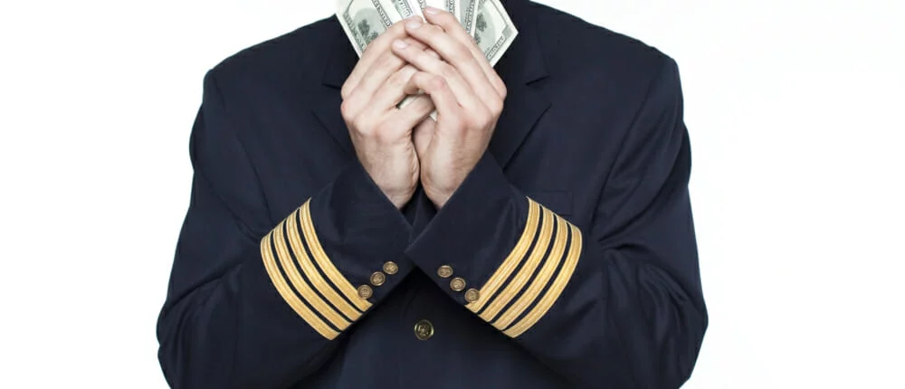 Young man in the form of a passenger plane pilot How much does commercial flight training cost?